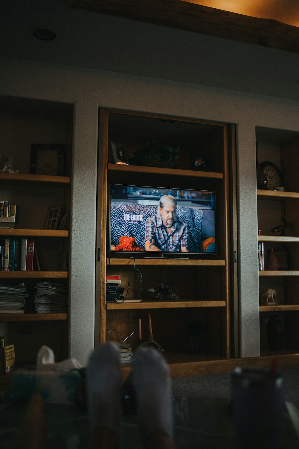 black flat screen tv turned on displaying man in blue suit jacket