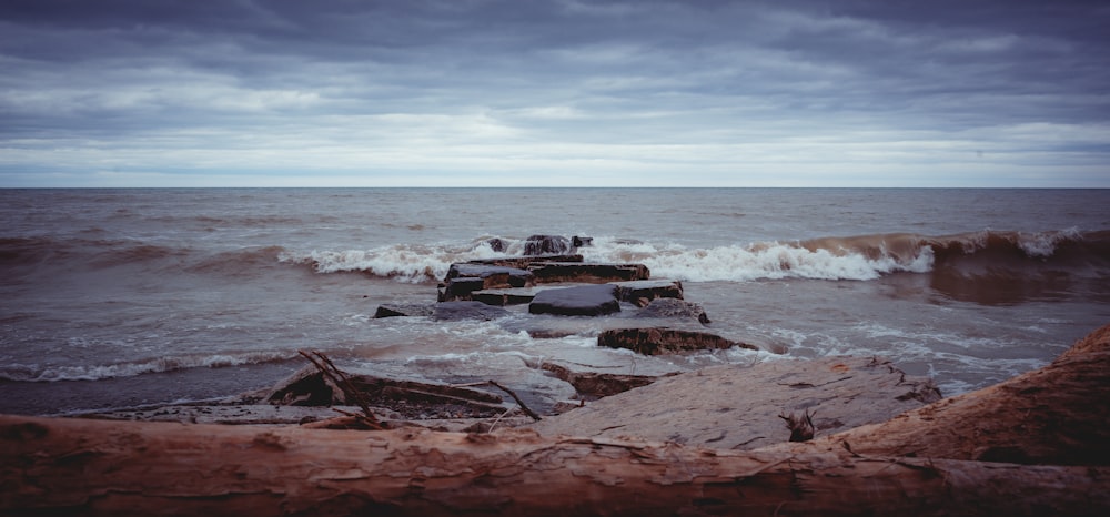 brown rock formation on sea during daytime