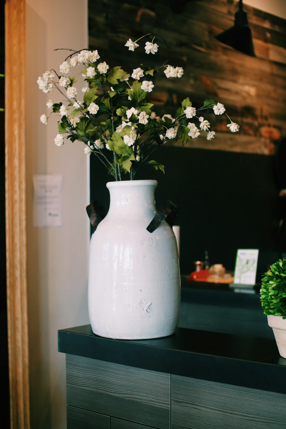 white flowers in white ceramic vase