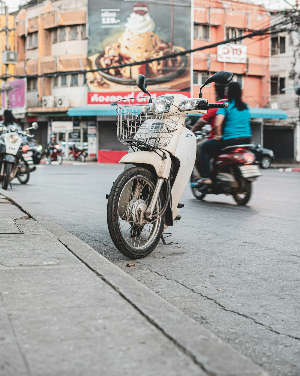 white and black motorcycle on road during daytime