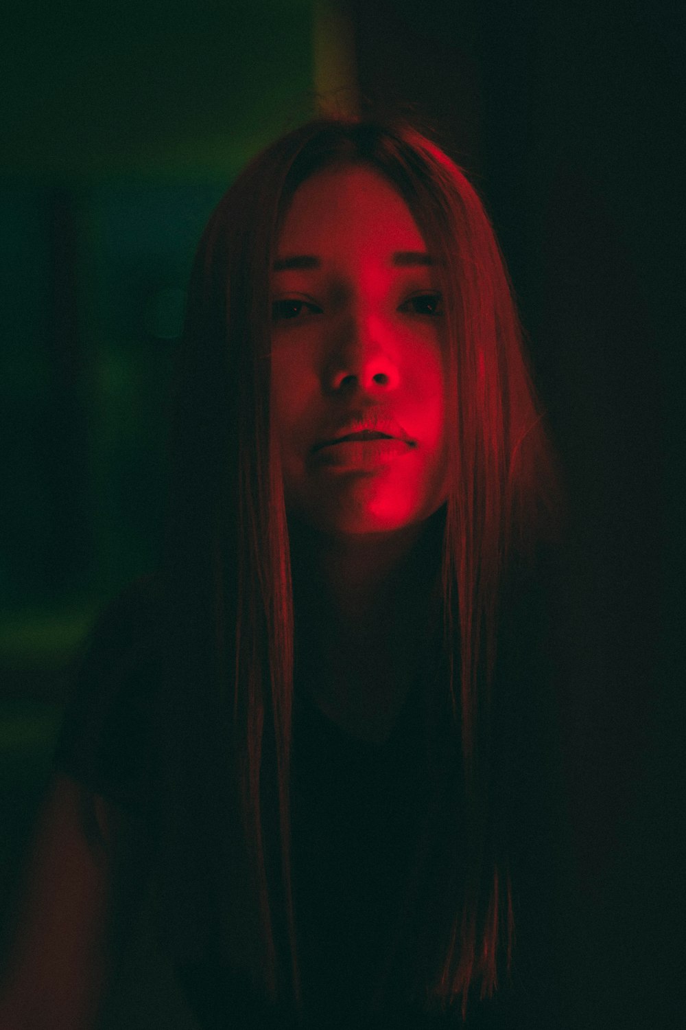 woman with red hair in dark room