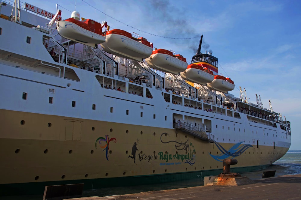 white and green ship on dock during daytime