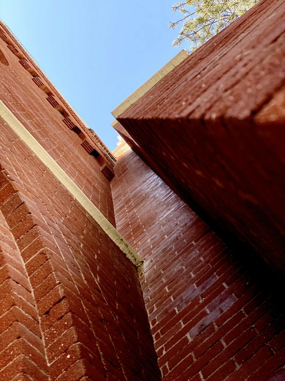 brown brick wall under blue sky during daytime