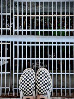 A vibrant shot of casual slip-on shoes paired with a flowing summer dress outdoors.