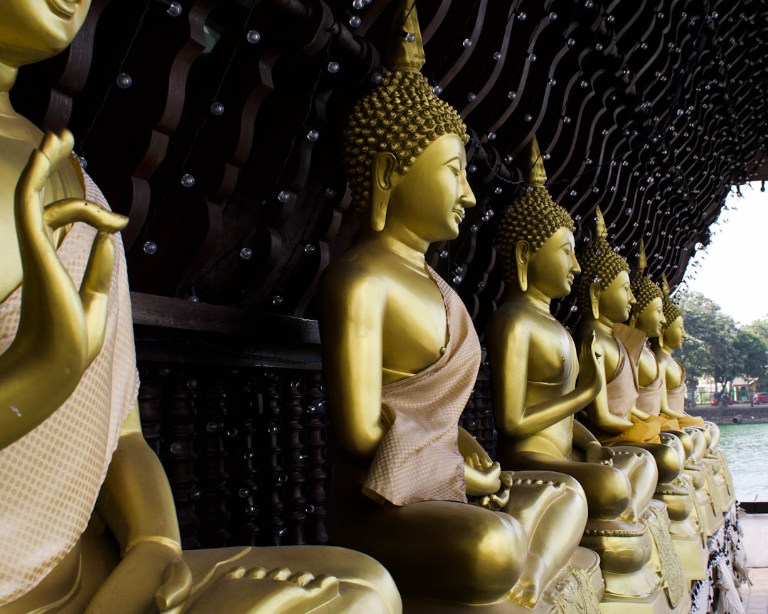 gold buddha statue on black metal frame,