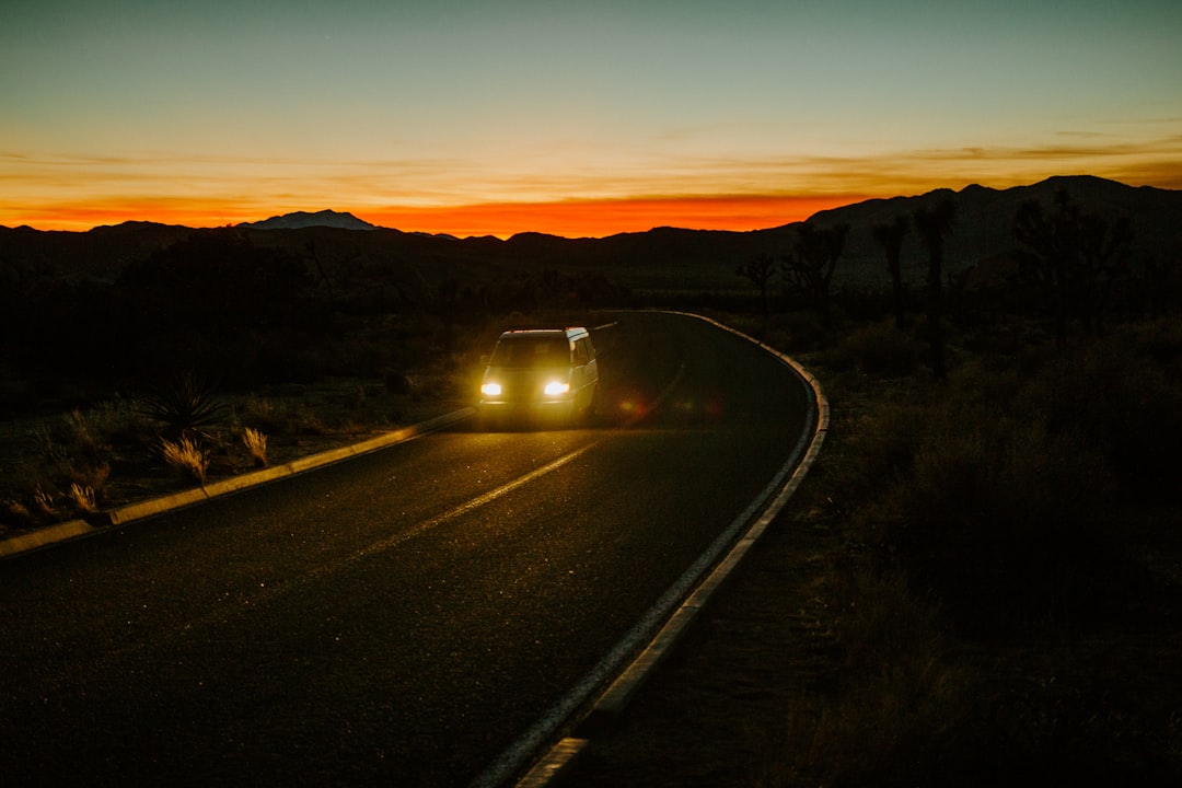 black car on road during sunset