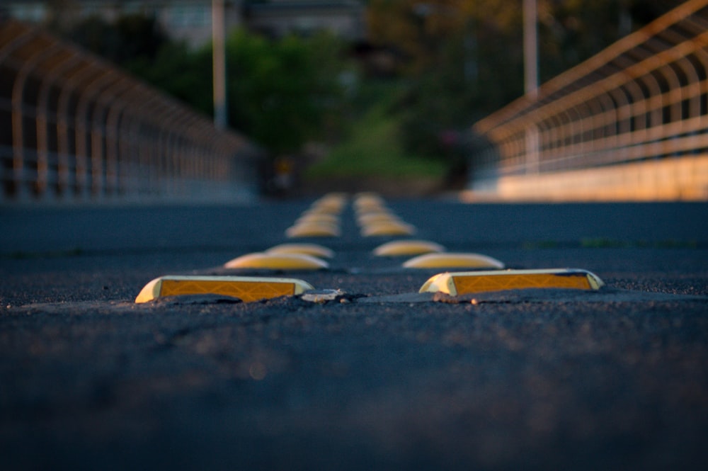 black and white adidas sneakers on gray concrete road