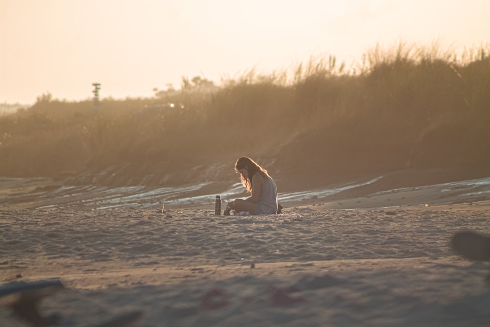 woman in white long sleeve shirt sitting on white wooden fence during daytime