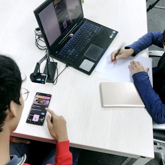 person in blue long sleeve shirt using black laptop computer