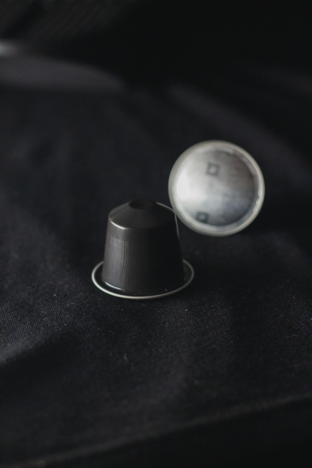 silver round ornament on black textile