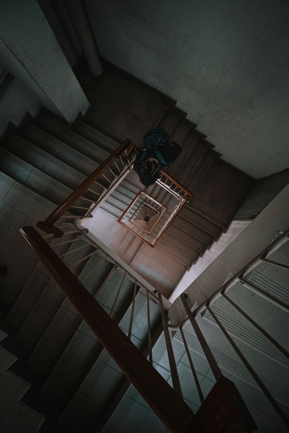 brown wooden staircase with white wooden railings