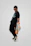 A vibrant urban streetwear look featuring a person wearing a stylish black t-shirt from the vibranero collection.