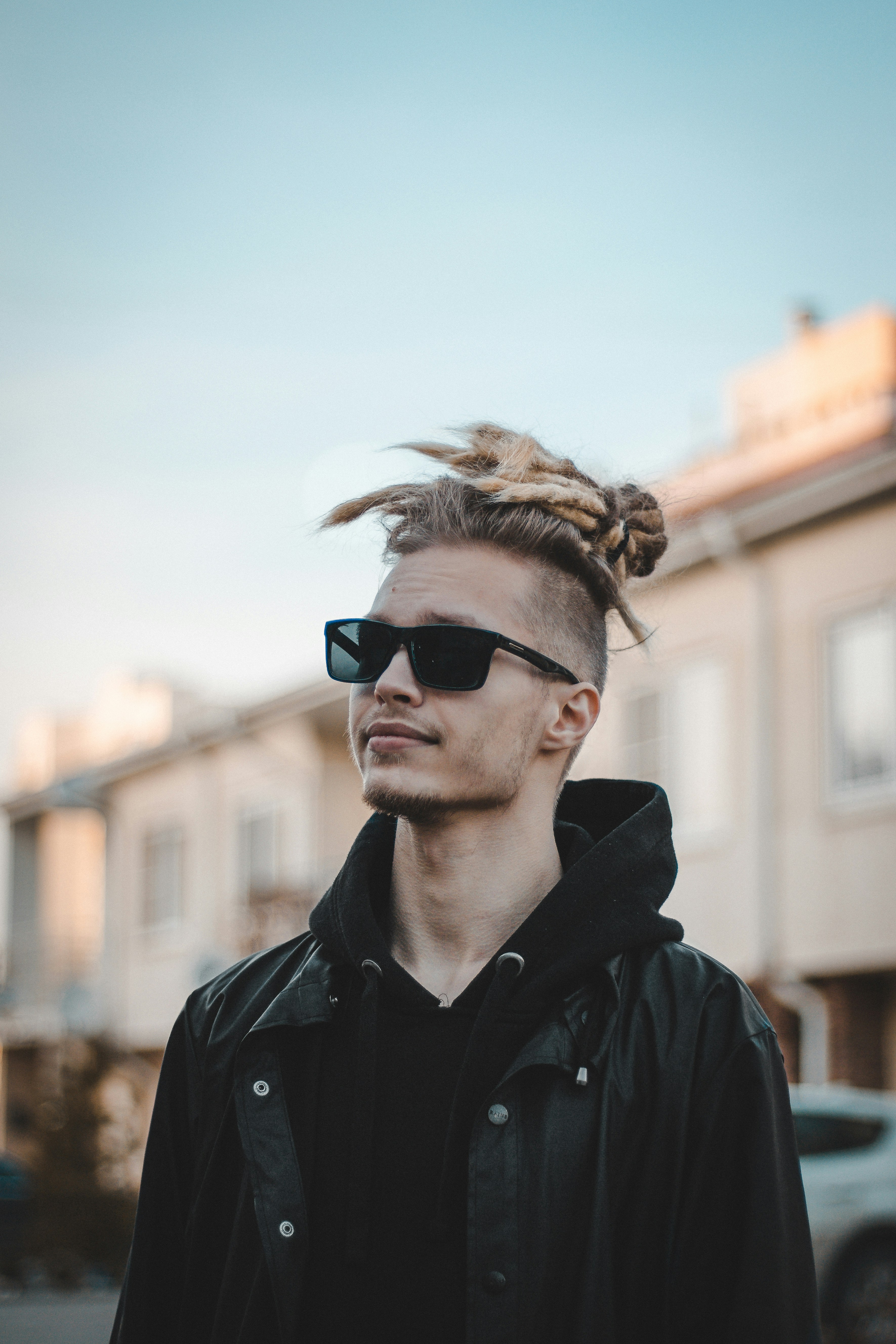 man in black jacket wearing black sunglasses