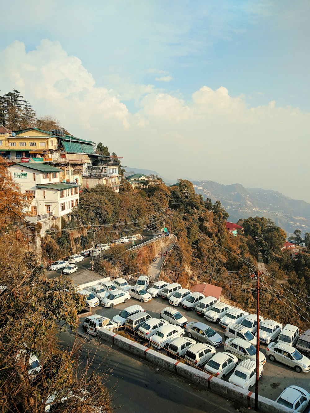 white and brown concrete buildings near green trees during daytime