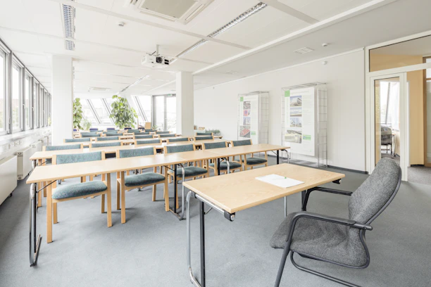 Professional cleaning team sanitizing a classroom with natural light.