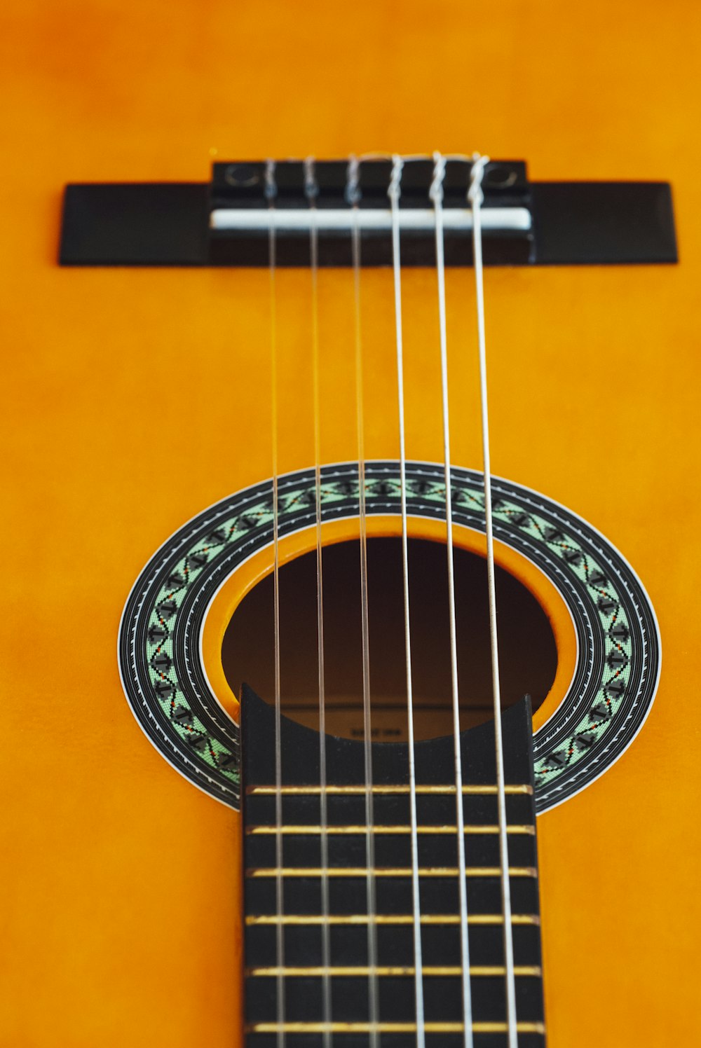 brown acoustic guitar in close up photography