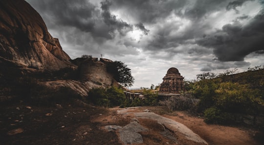 brown concrete building under gray clouds in Gudibande Fort India