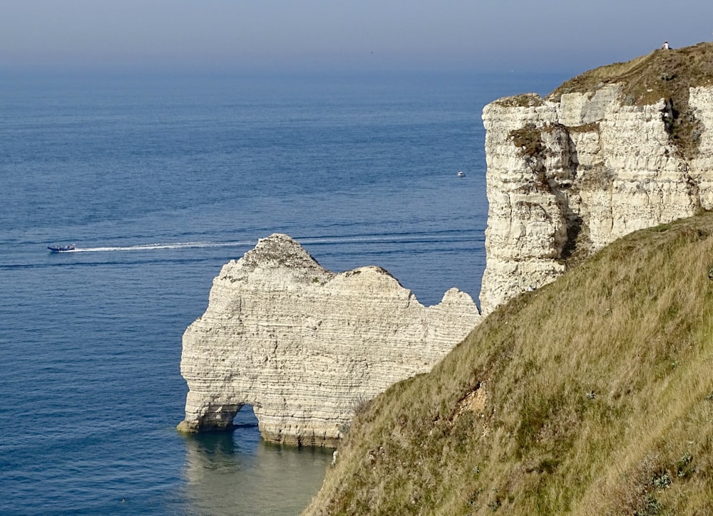 white rock formation on blue sea during daytime