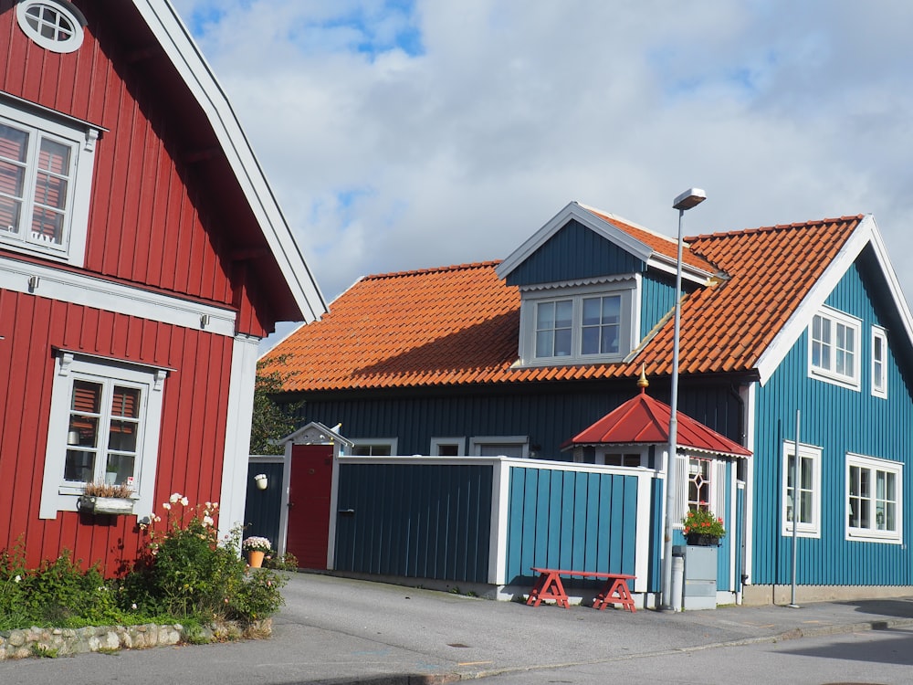 red and white wooden house under white clouds during daytime