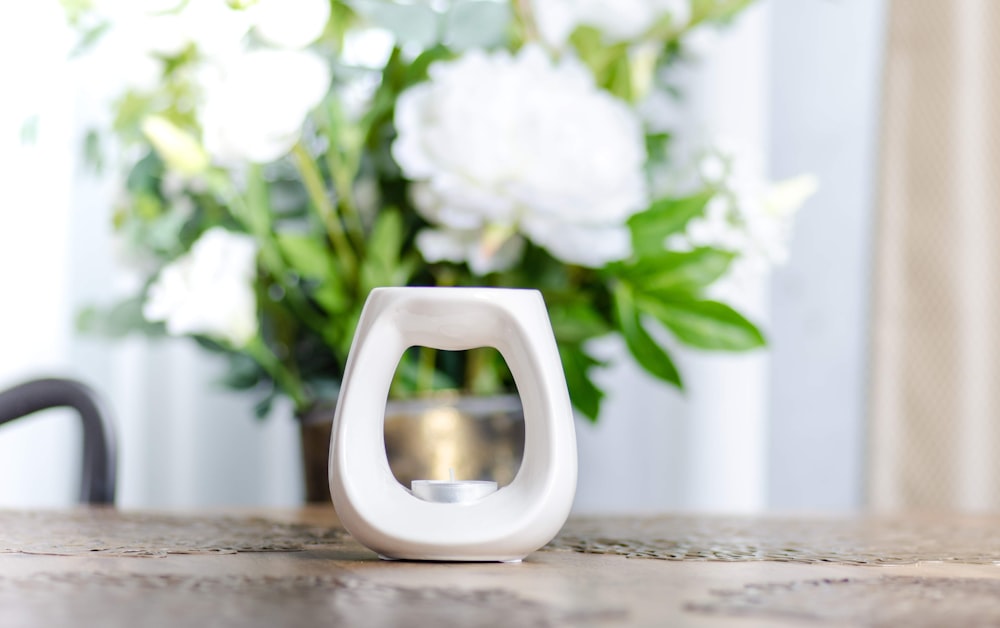 white ceramic mug on brown wooden table