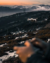 A drone flying over a scenic mountain landscape during golden hour.