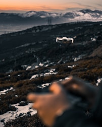 Custom drone flying high over a mountain landscape at sunset