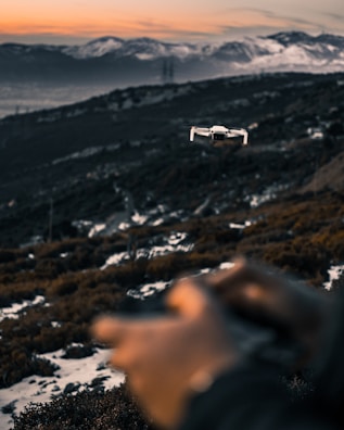 Drone flying over a scenic mountain landscape at sunset