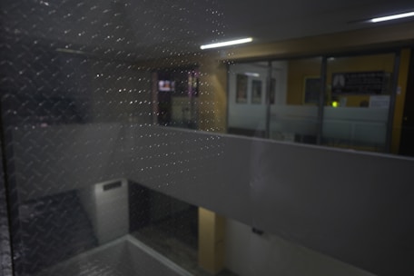 high-quality, photorealistic image of a water-damaged room being restored by skilled technicians, using industrial fans and dehumidifiers, water stains visible but controlled, clean and organized workspace, neutral or dark background, professional lighting, realistic, no text, no logos