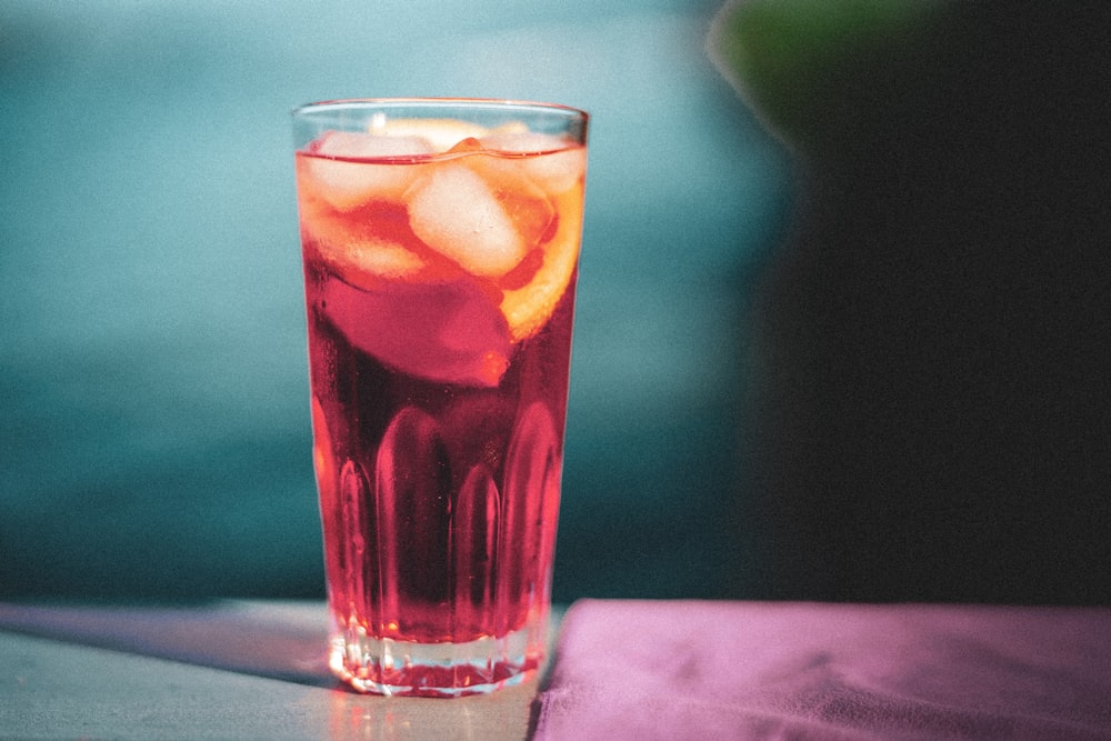 clear drinking glass with pink liquid