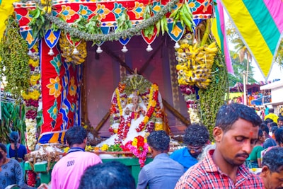 A vibrant community event organized by abhinavasampada, showing smiling faces and colorful decorations.