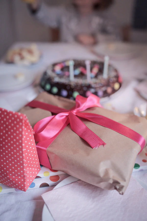 Child opening a birthday present at a party