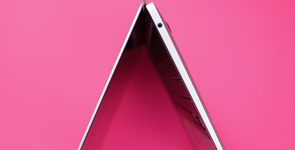 Clean and minimalist website design illustration with a laptop and soft violet accents.