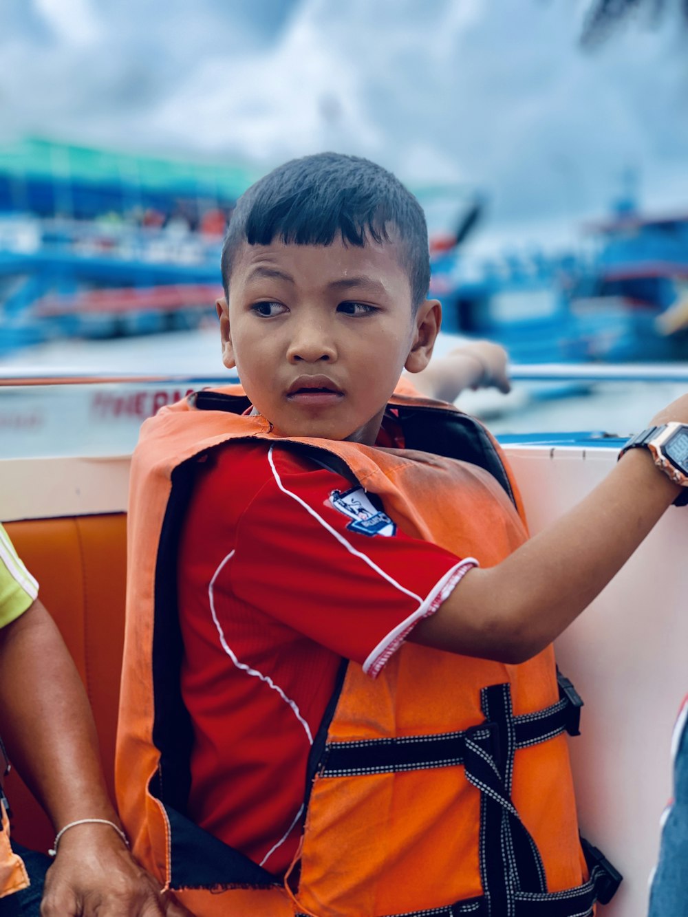 boy in orange and black jersey shirt