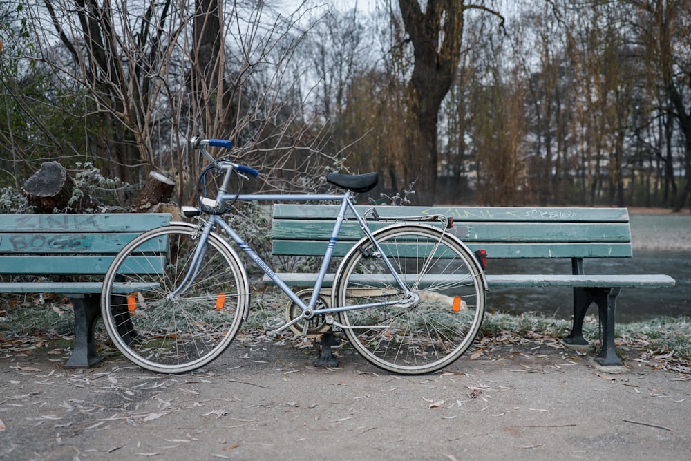 blue city bike on gray wooden bench