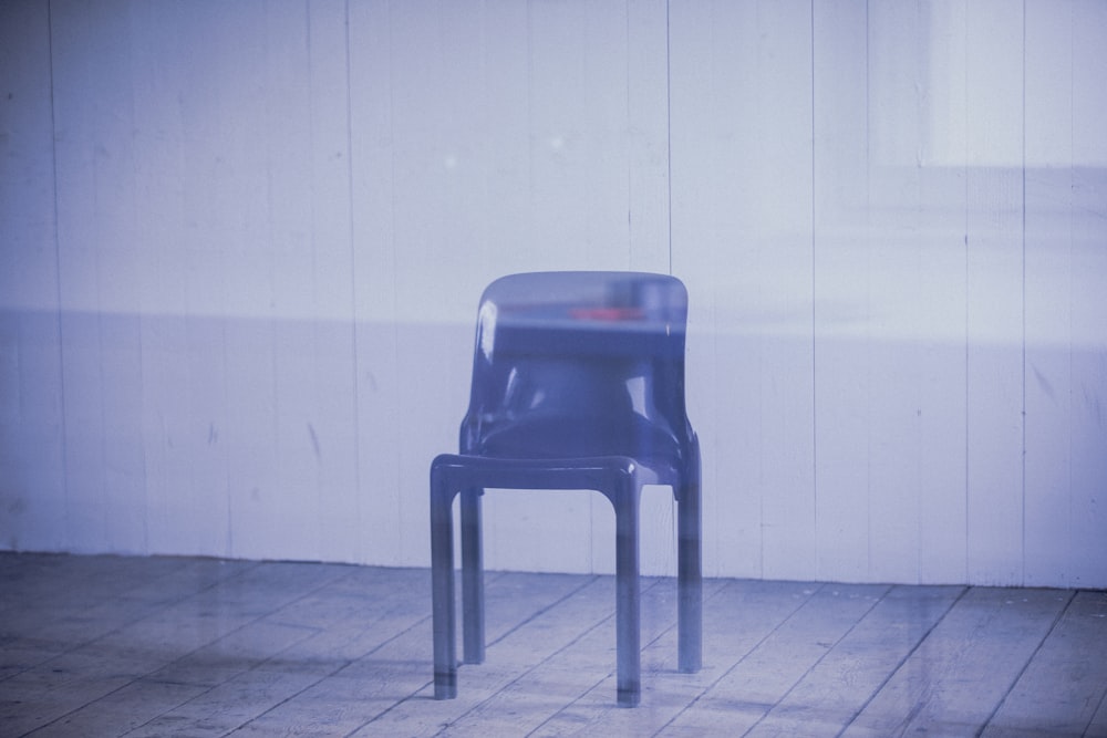 blue plastic chair on white floor tiles