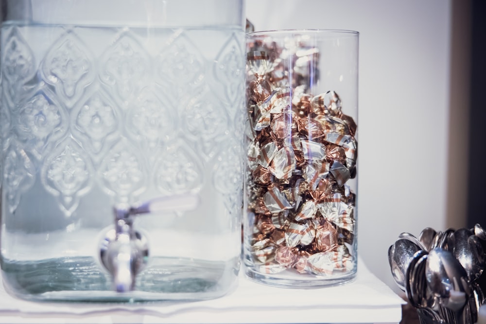 clear glass bottle with brown and white stones