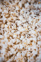 Close-up of freshly popped popcorn inside the iccaro vending machine, steam rising gently.