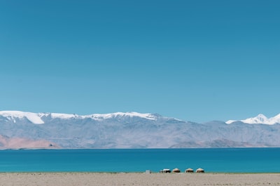 white and black mountains under blue sky during daytime tajikistan teams background