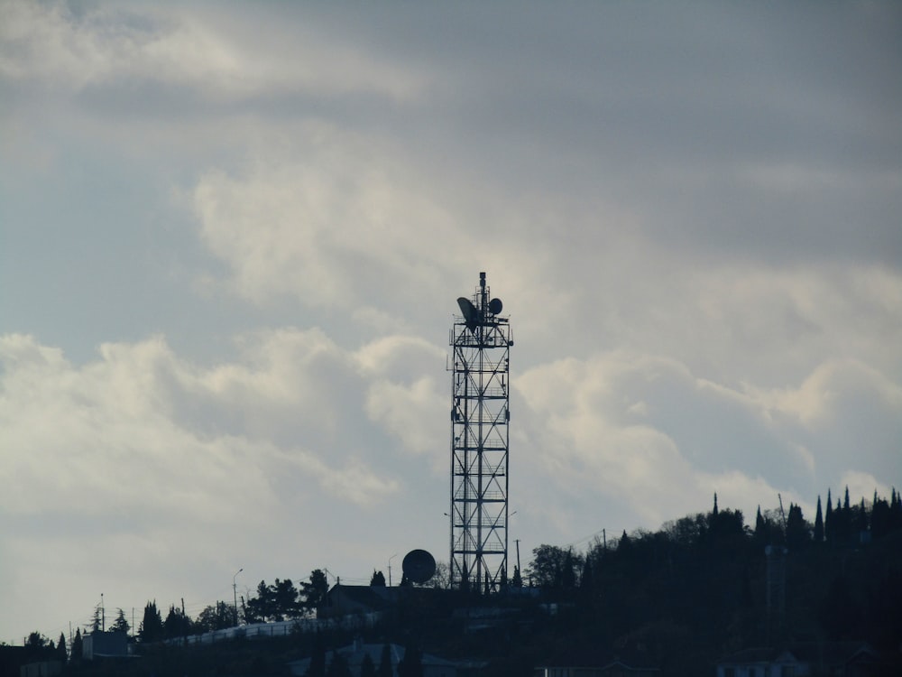 white and black tower under white clouds