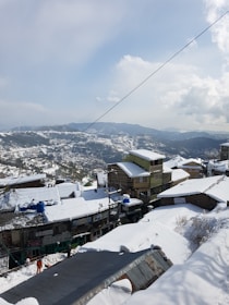 houses on snow covered ground during daytime