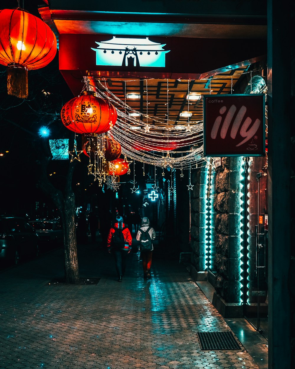 people walking on sidewalk during night time