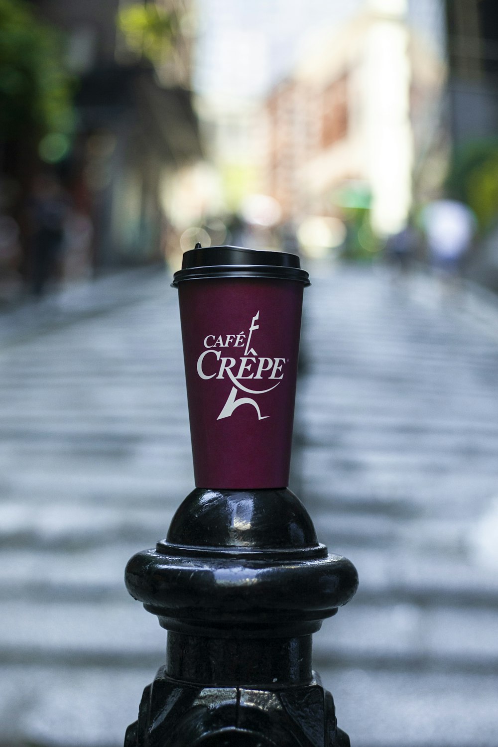 red and black plastic cup on black metal stand