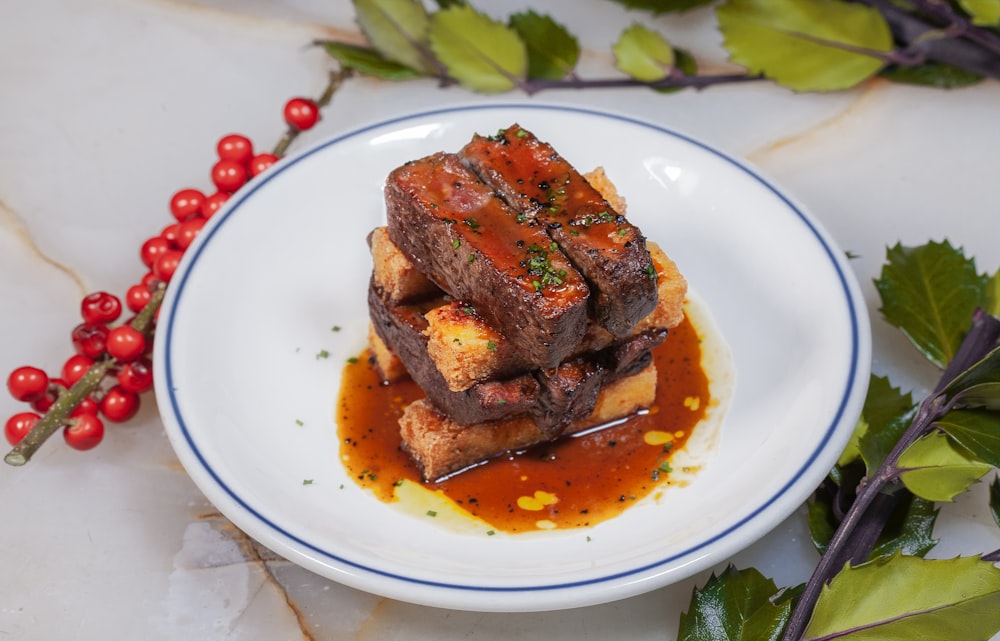 cooked meat on white ceramic plate