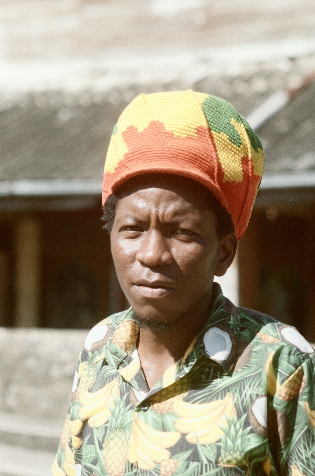 man in yellow green and red knit cap and yellow green and blue floral button up