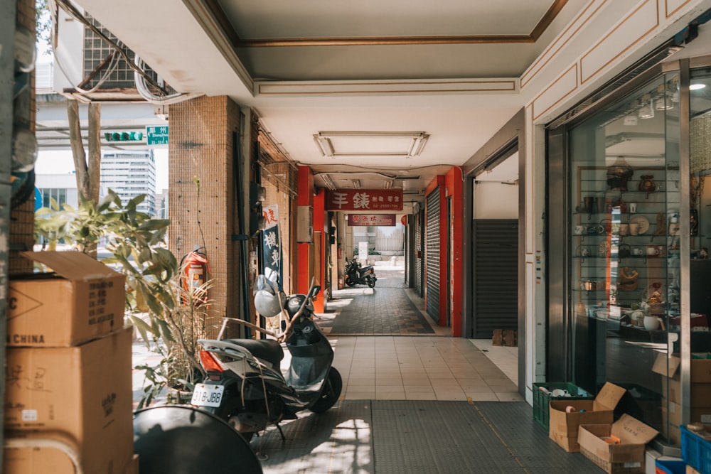 black motorcycle parked beside brown building