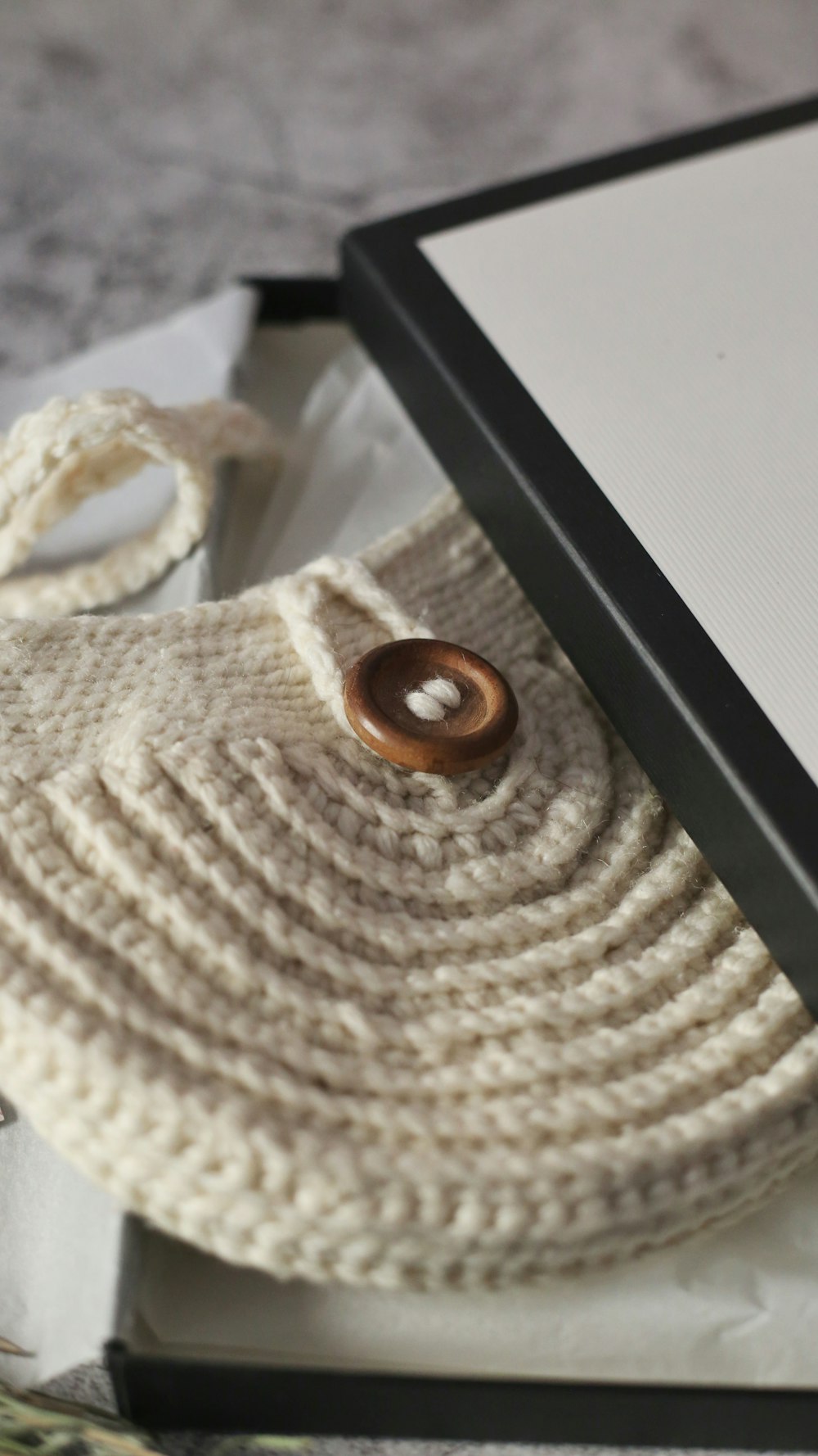 brown round ornament on white knit textile