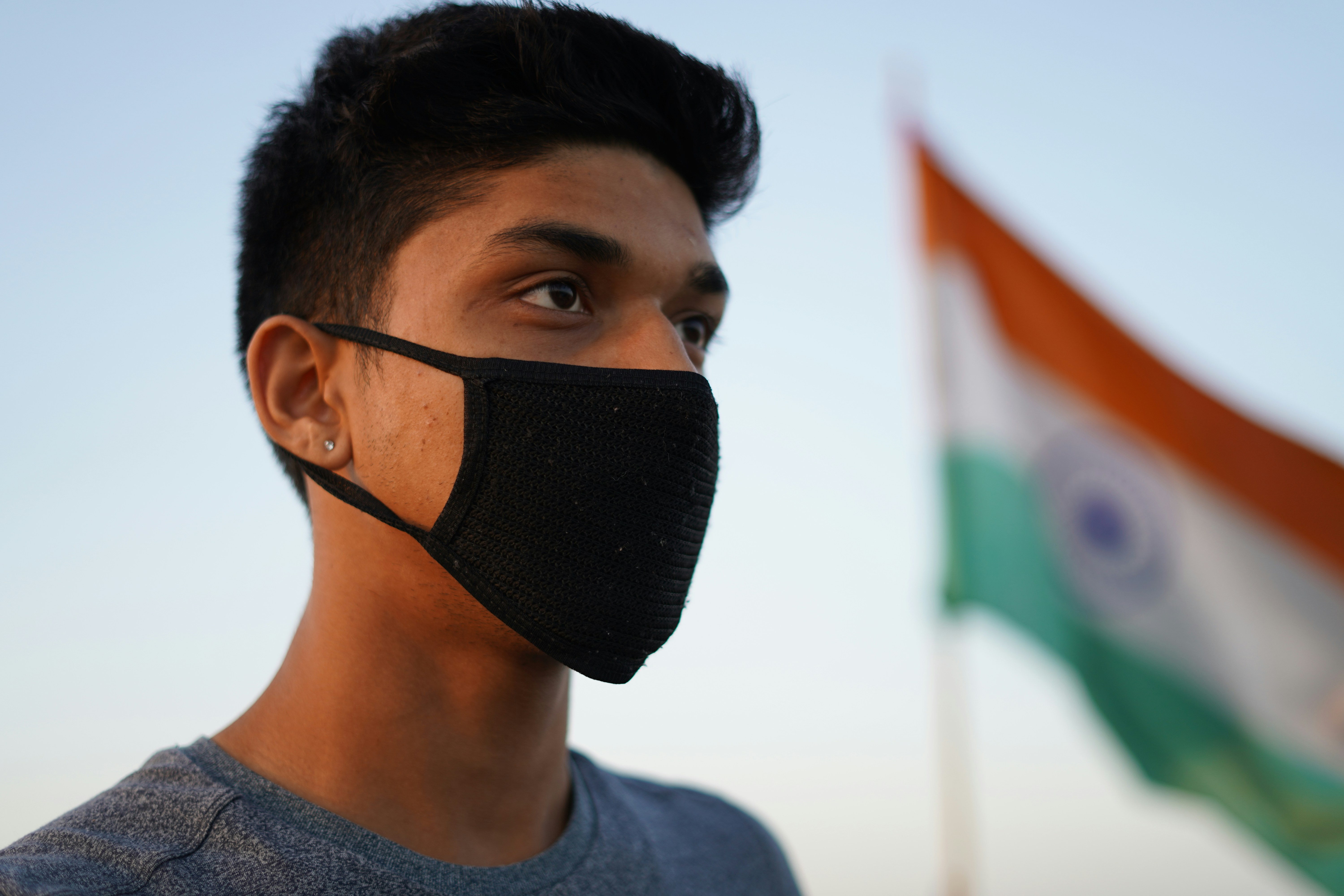 Man in gray crew neck shirt wearing black knit cap