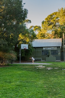 woman in white shirt and white pants playing golf during daytime