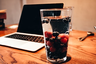 Customer filling out a contact form on a laptop with frozen berries on the side.