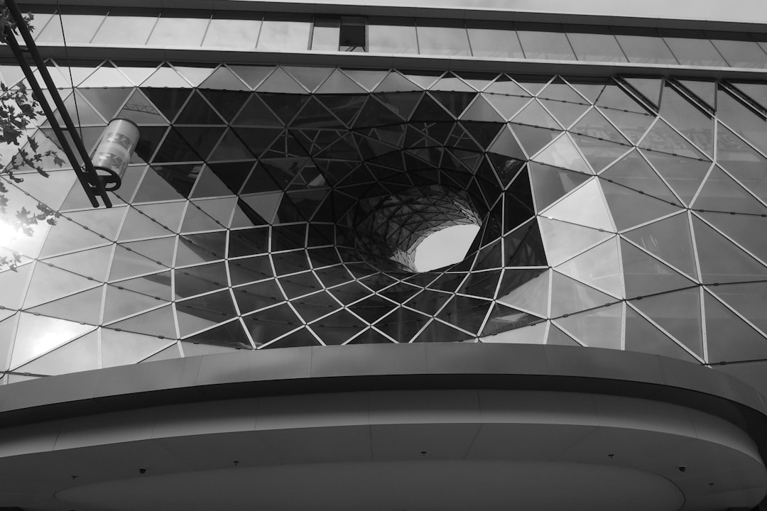 grayscale photo of round concrete building